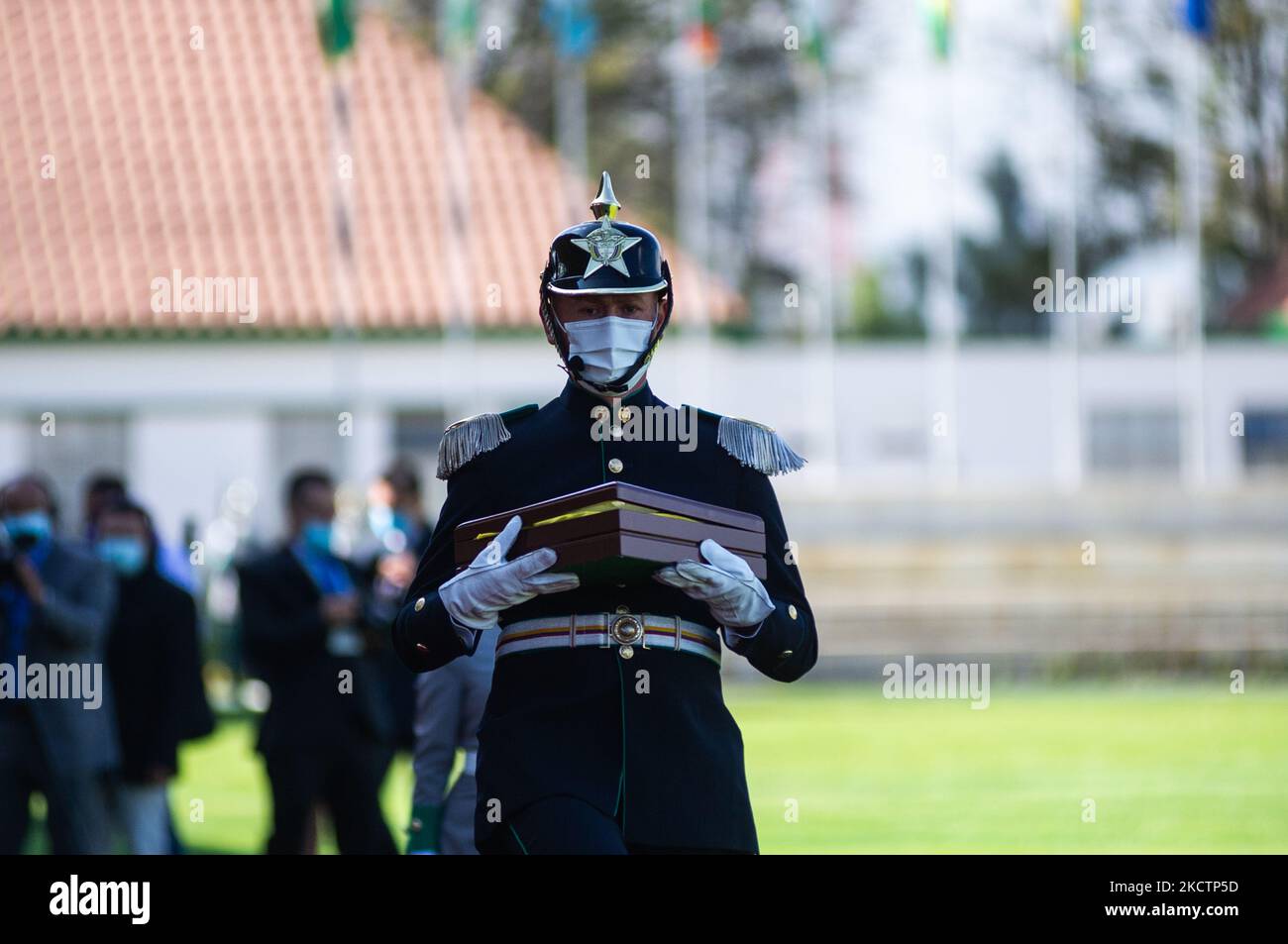 A member of the Police carries a flag of Colombia inside a wooden box that is used to remember the officers who lost their lives during an event were Colombia's president Ivan Duque Marquez and Colombia's Minister of Defense Diego Molano in conmmemoration of the 130 anniversary of Colombia's National Police and the promotion to officers to more than a 100 police members, in Bogota, Colombia on November 11, 2021. (Photo by Sebastian Barros/NurPhoto) Stock Photo