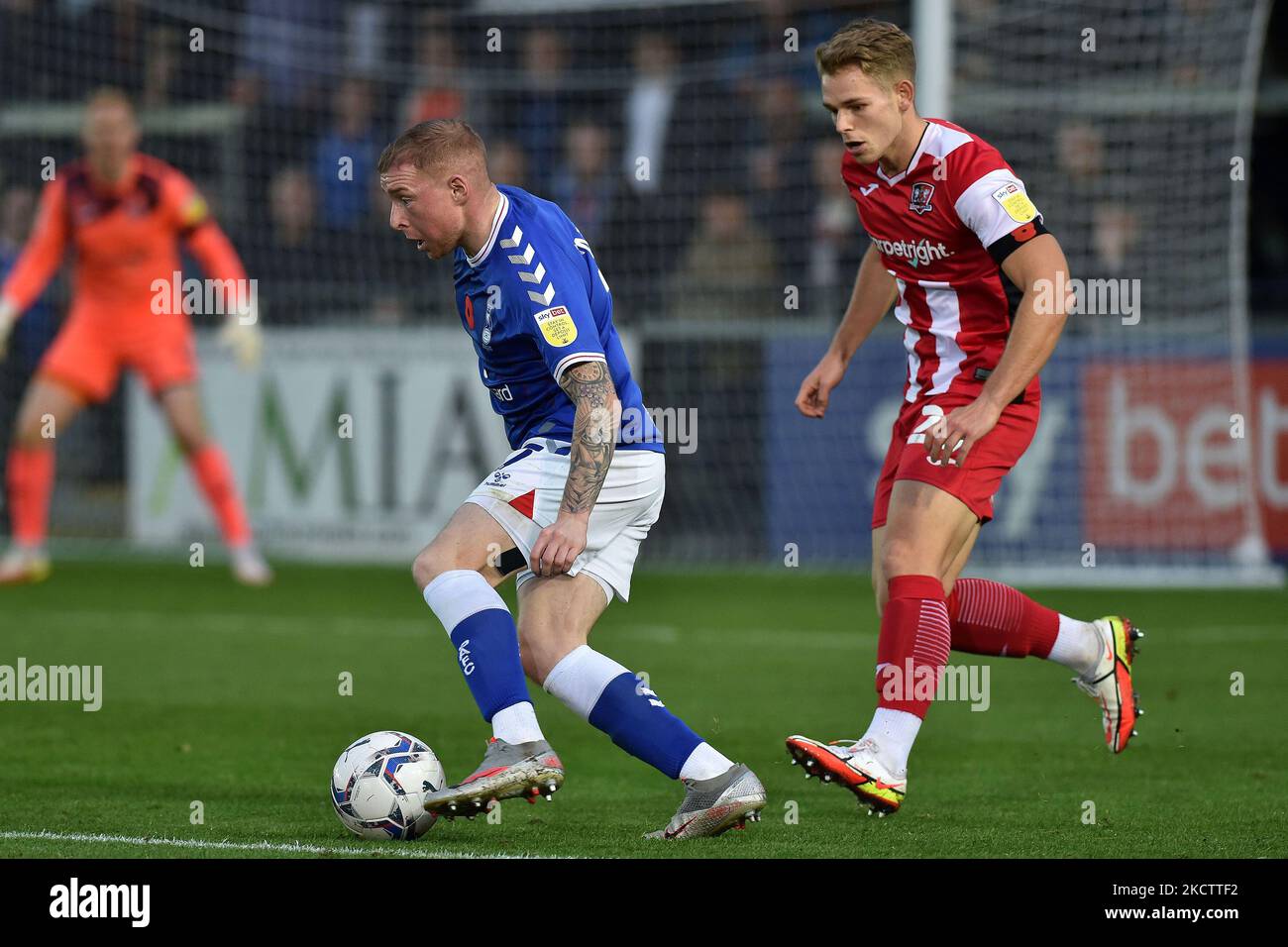 Oldham Athletic's Nicky Adams tussles with Harry Kite of Exeter City ...