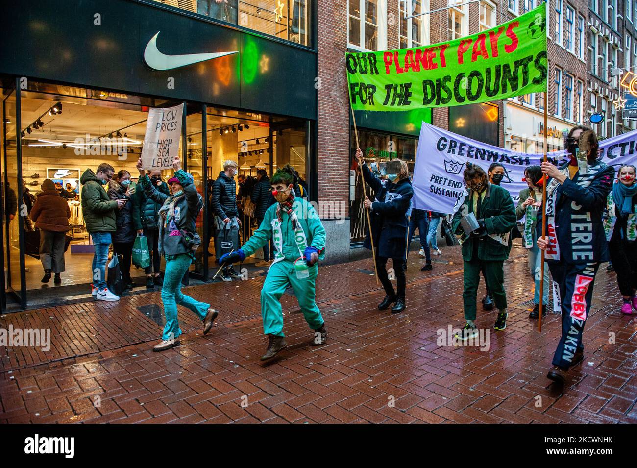 A group of Extinction Rebellion activists is walking along the busiest shopping street, while holding banners against Black Friday and fast fashion, during a fashion parade organized by XR, against Black Friday in Amsterdam, on November 27th, 2021. (Photo by Romy Arroyo Fernandez/NurPhoto) Stock Photo