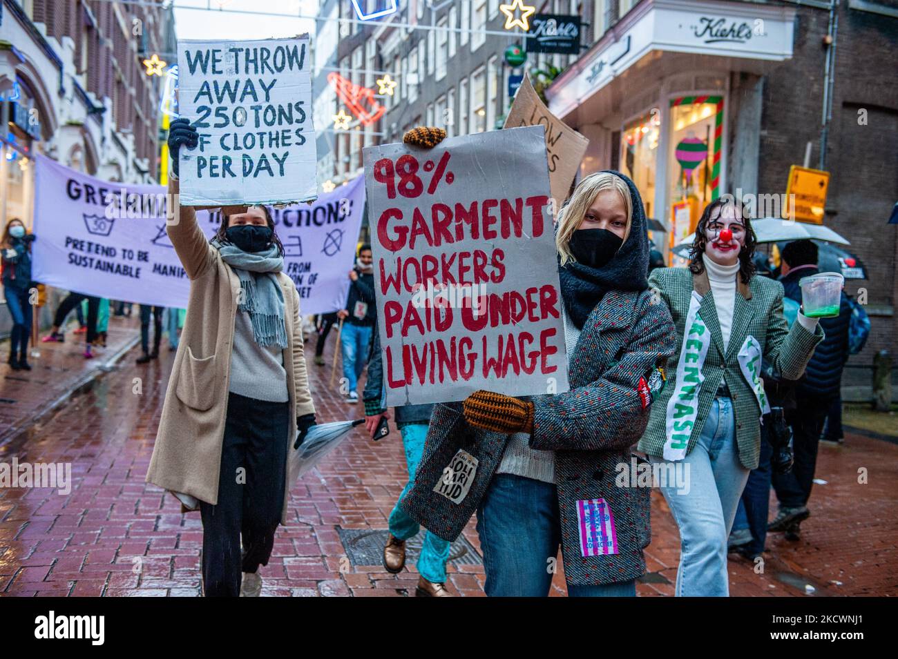 A group of Extinction Rebellion activists is walking along the busiest shopping street, while holding banners against Black Friday and fast fashion, during a fashion parade organized by XR, against Black Friday in Amsterdam, on November 27th, 2021. (Photo by Romy Arroyo Fernandez/NurPhoto) Stock Photo