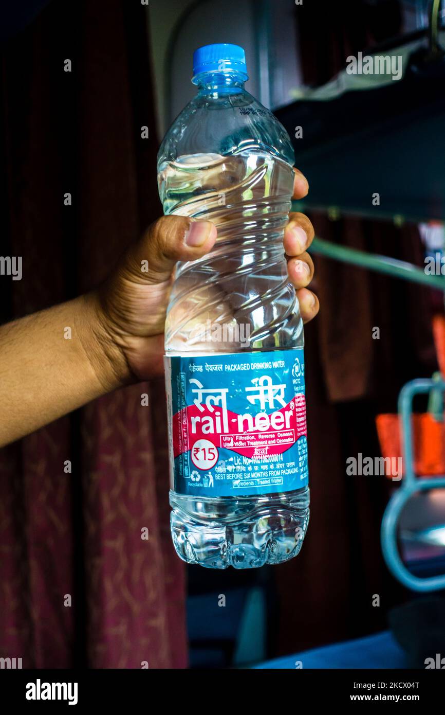 July 4th 2022 Haridwar India. A man holding Rail Neer packaged drinking water bottle offered by Indian Railways. Stock Photo
