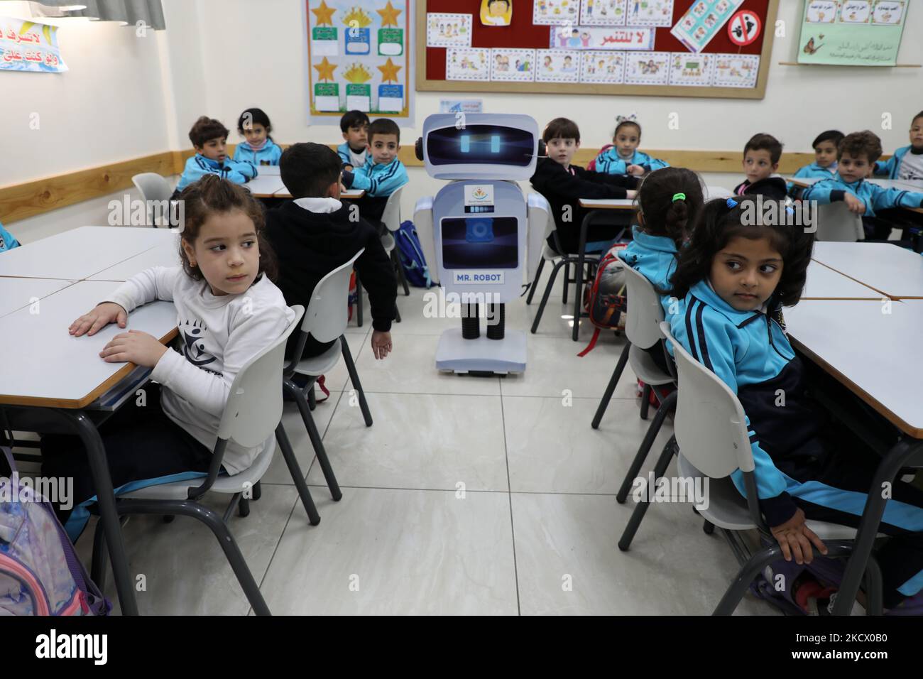 Palestinian students interact with a locally-made educational robot during a science class at a private school in Gaza City on November 30, 2021. (Photo by Majdi Fathi/NurPhoto) Stock Photo