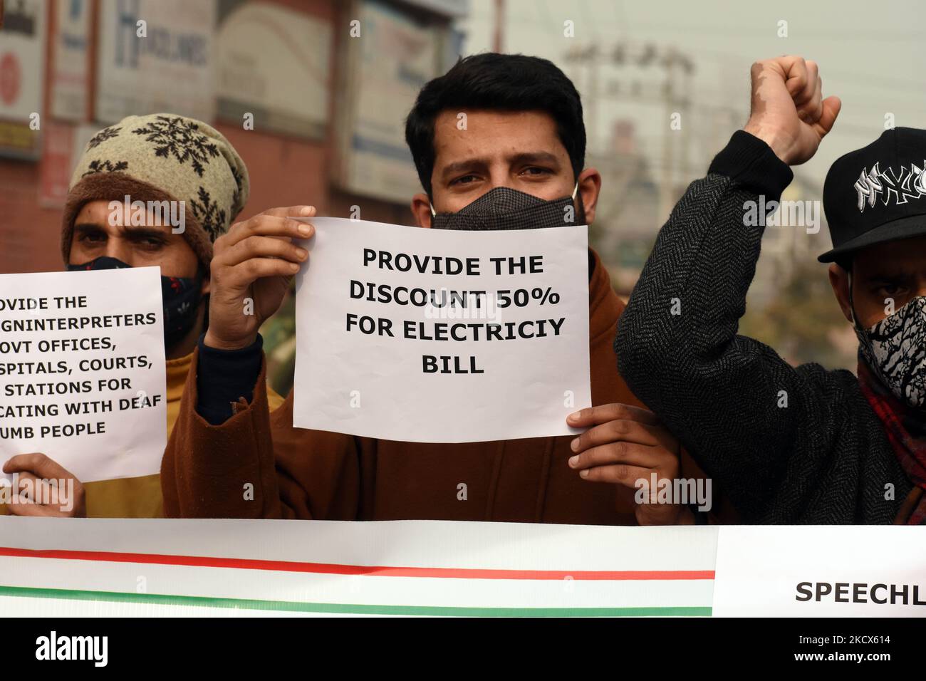 Disable persons hold placards as they protest against the
