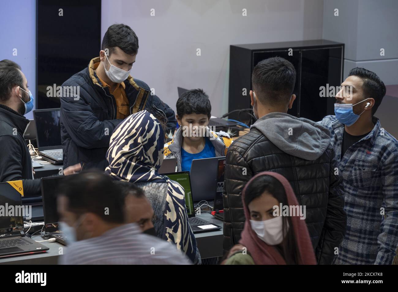 An Iranian young boy looks at a laptop in an IT-City multi brand shop at the Paytakht computer centre in northern Tehran on December 2, 2021. Despite US sanctions against Iran, Iranians have access to the latest technology in the world of telecommunications and digital, but in most cases at a higher price than the global value of technology goods, but the Iranians prefer to keep themselves update themselves in the field of the computers and telecommunication technology. Even though they have to have to get loan to buy a new smartphone like the iPhone 13. MORTEZA NIKOUBAZL/NurPhoto (Photo by Mo Stock Photo