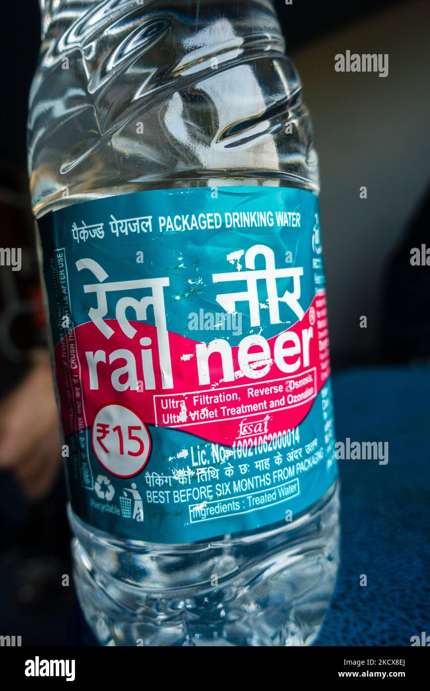 July 4th 2022 Haridwar India. A man holding Rail Neer packaged drinking water bottle offered by Indian Railways. Stock Photo