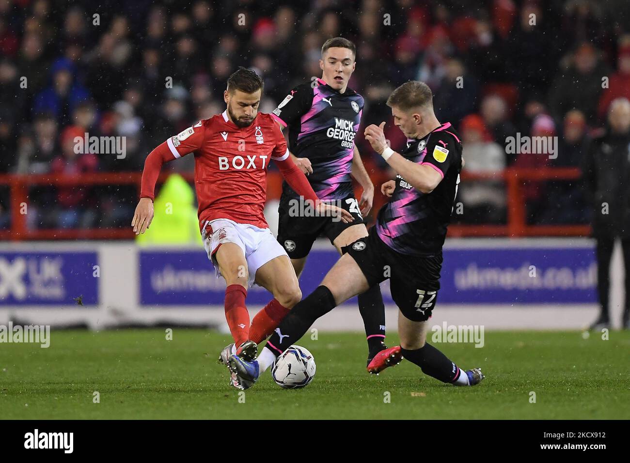 Josh Knight of Peterborough United tackles Philip Zinkernagel of Nottingham Forest during the Sky Bet Championship match between Nottingham Forest and Peterborough at the City Ground, Nottingham on Saturday 4th December 2021. (Photo by Jon Hobley/MI News/NurPhoto) Stock Photo