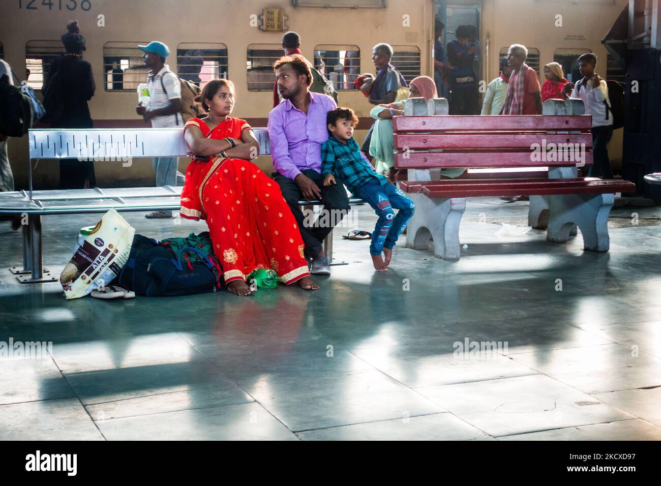 July 4th 2022 Punjab India. A small town family, husband wife and their kid waiting on a Railway platform with luggage. India Stock Photo