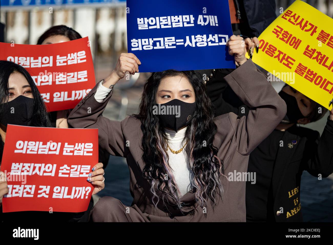 Members of the Korean Association of Tattoo Artists hold placards at the contest to urge the enactment of the tattoo law in front of the Yeouido National Assembly on December 08, 2021 in Seoul, South Korea. In South Korea, it is considered illegal medical practice if those who are not doctors under the current medical law perform tattoos. The tattooists have filed three constitutional wishes since 2017, and it is said that the court is currently under consideration. (Photo by Chris Jung/NurPhoto) Stock Photo