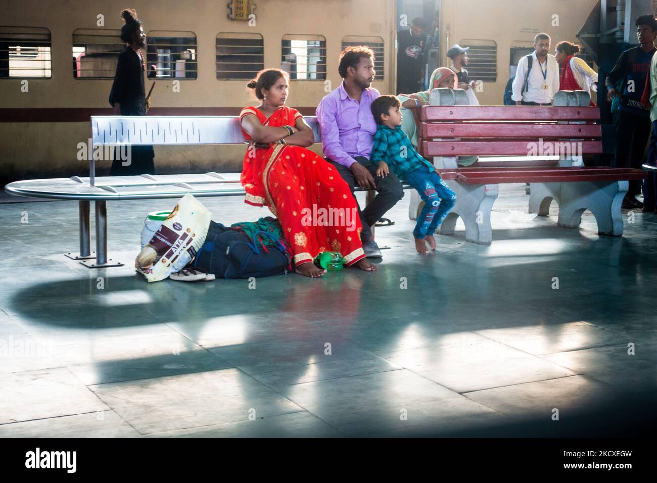 July 4th 2022 Punjab India. A small town family, husband wife and their kid waiting on a Railway platform with luggage. India Stock Photo