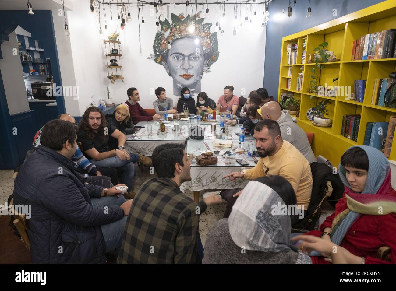 A group of Iranian youths speak with each other as they sit together in ...
