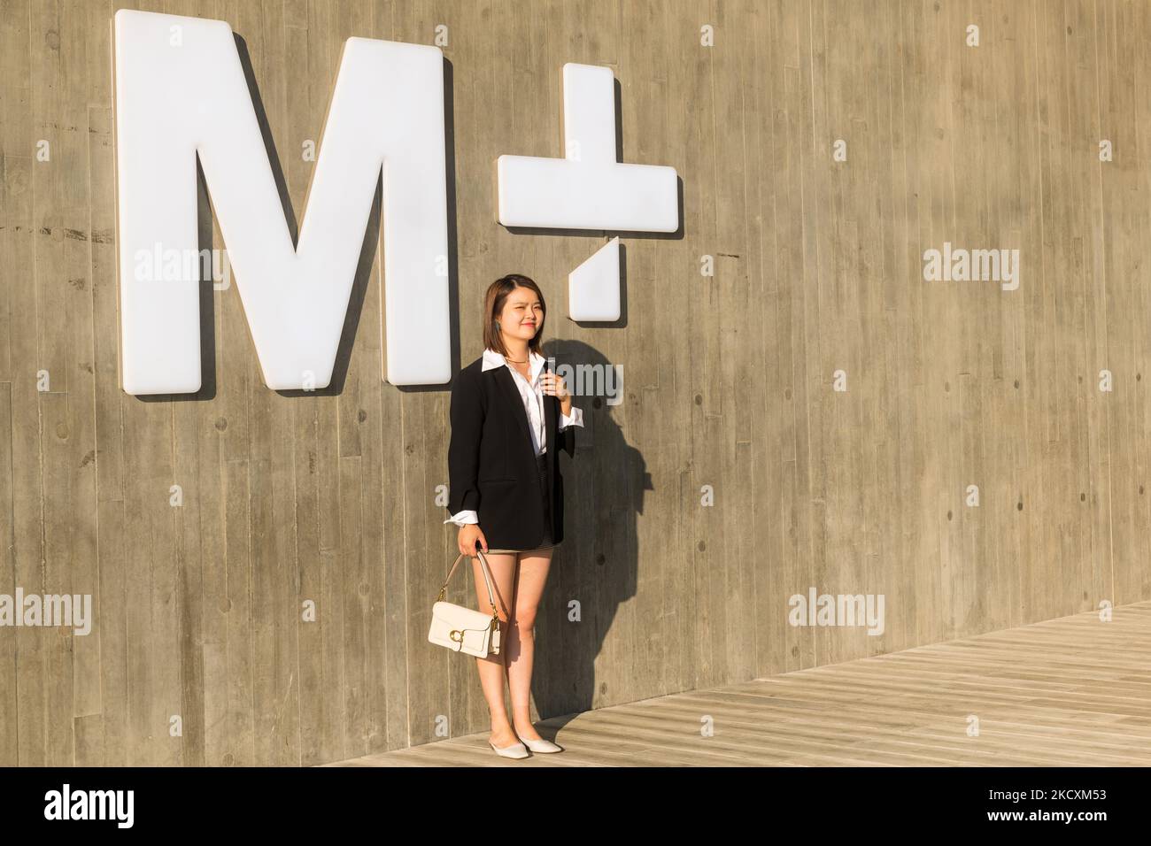 Hong Kong, China, 11 Dec 2021, A young lady poses in front of the 