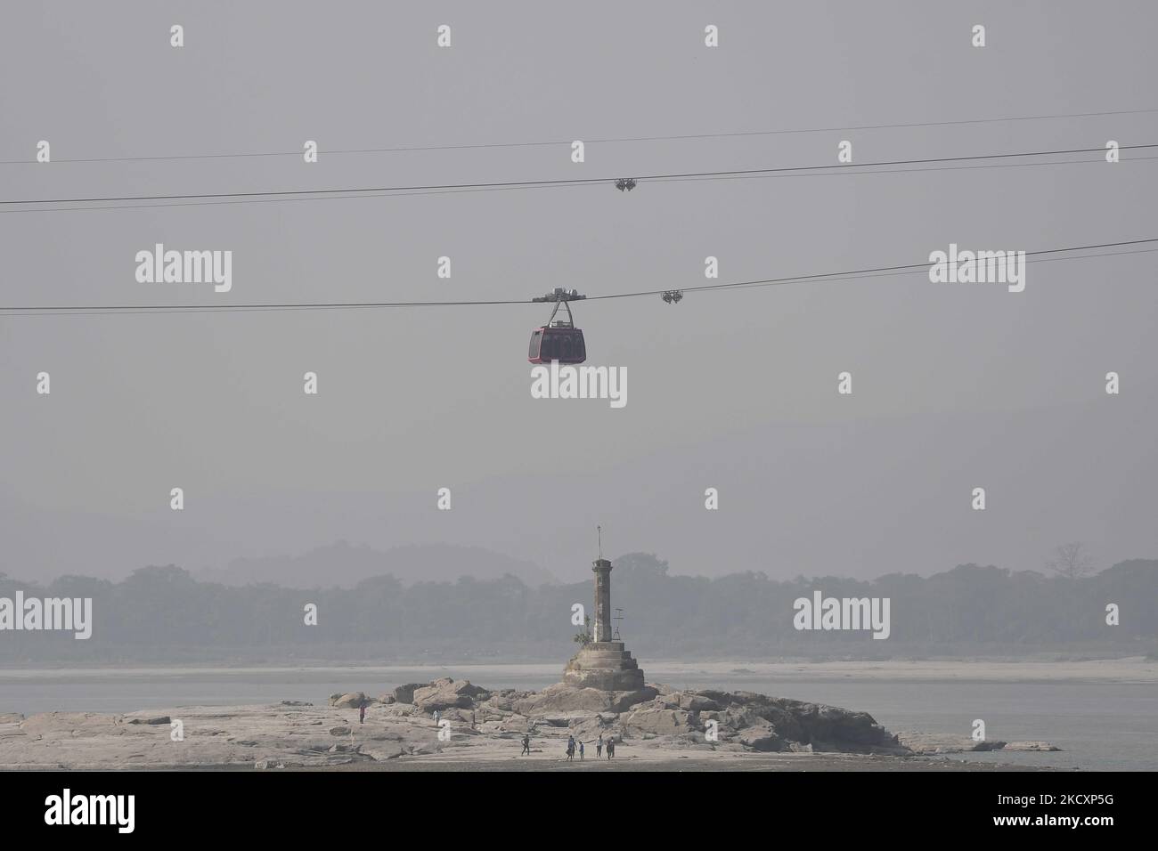 People travel on a cable car cabin in the India's longest river ropeway