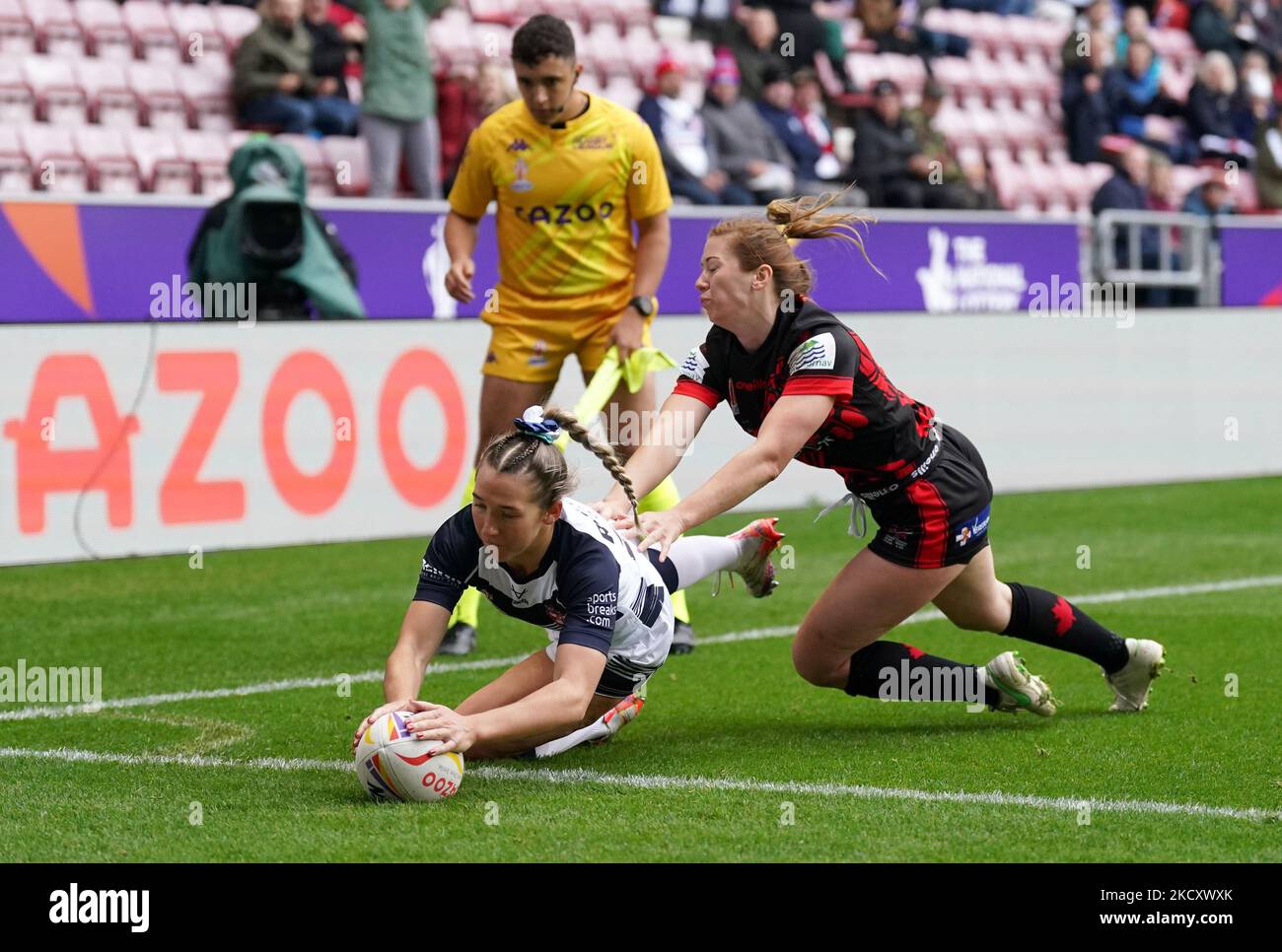 Canada's Lauren Mueller (right) fails to stop England's Georgia Wilson scores their side's third try during the Women's Rugby League World Cup Group A match at the DW Stadium, Wigan. Picture date: Saturday November 5, 2022. Stock Photo
