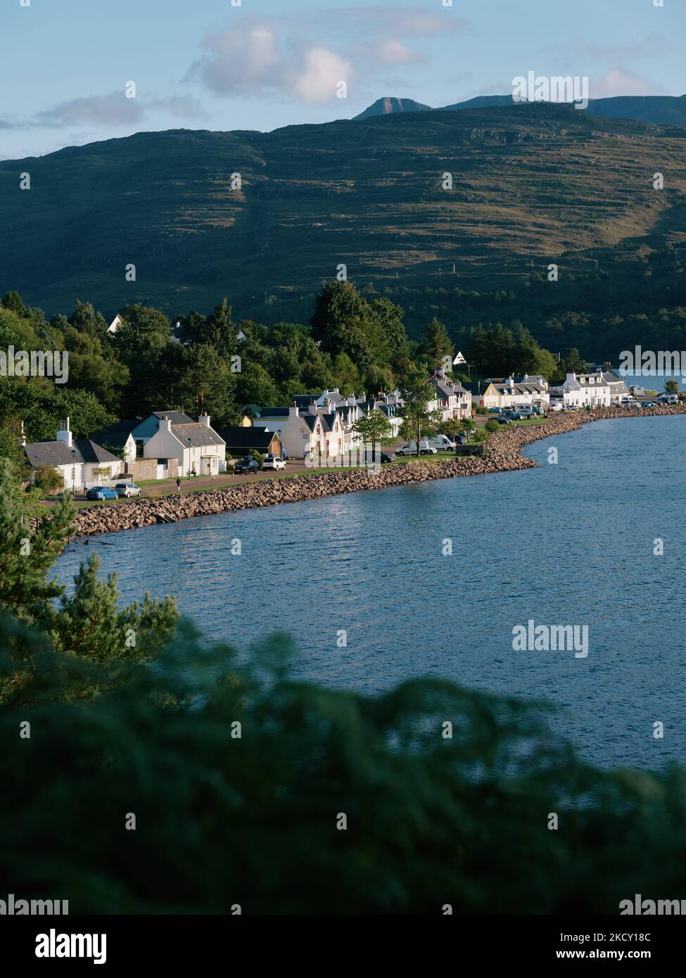 The summer loch and mountain landscape of Loch Shieldaig and village in Wester Ross, Highland, Scotland UK Stock Photo
