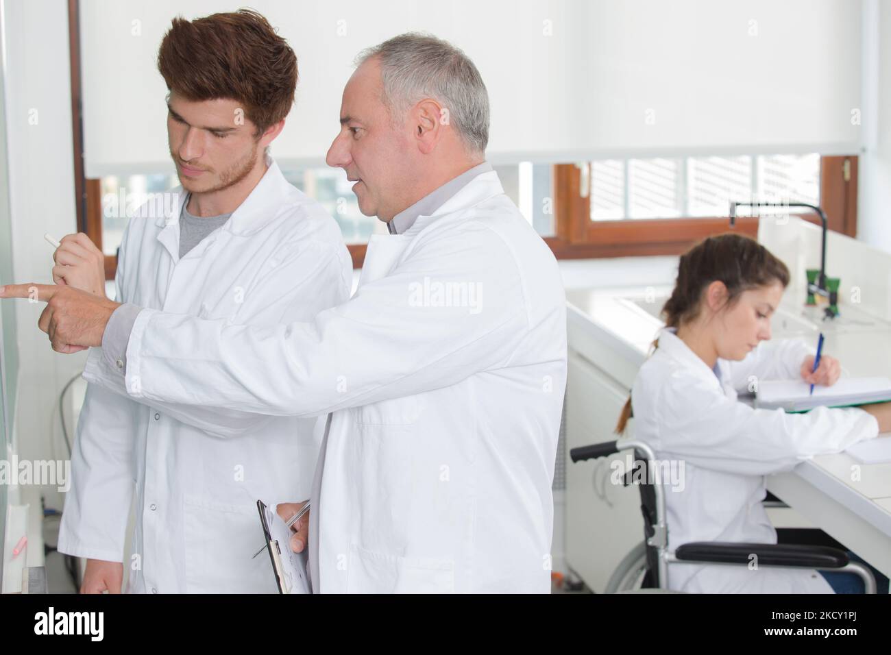 science student in wheelchair working at university Stock Photo Alamy