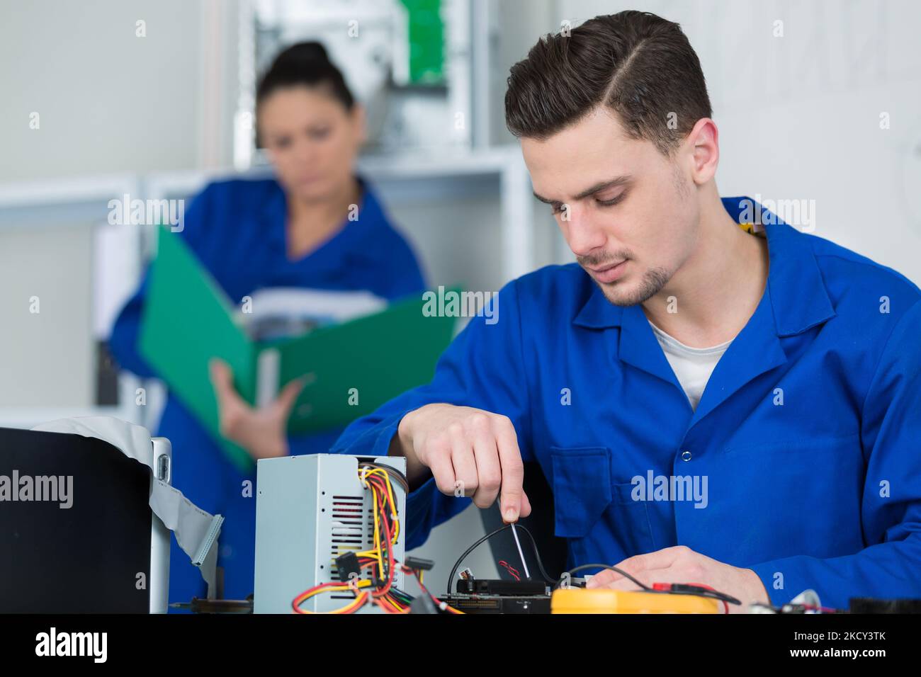 electricians working on an industrial power distribution center Stock