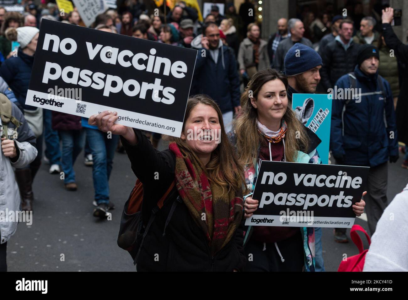 LONDON, UNITED KINGDOM - DECEMBER 18, 2021: Demonstrators march through central London during a protest against Covid-19 vaccines, vaccine passports and mandates after this week's Commons vote in favour of vaccine certificates for some larger venues as well as mandatory vaccinations for NHS and social care workers in England on December 18, 2021 in London, England. The measures approved by MPs are part of the government's winter Plan B introduced in response to the emergence of the new coronavirus variant - Omicron - and a rapid rise in cases in the run up to Christmas. (Photo by WIktor Szyman Stock Photo