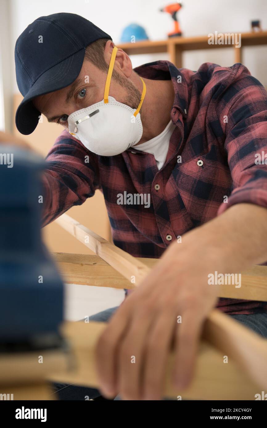 young man gluing wood pieces together in diy concept Stock Photo Alamy