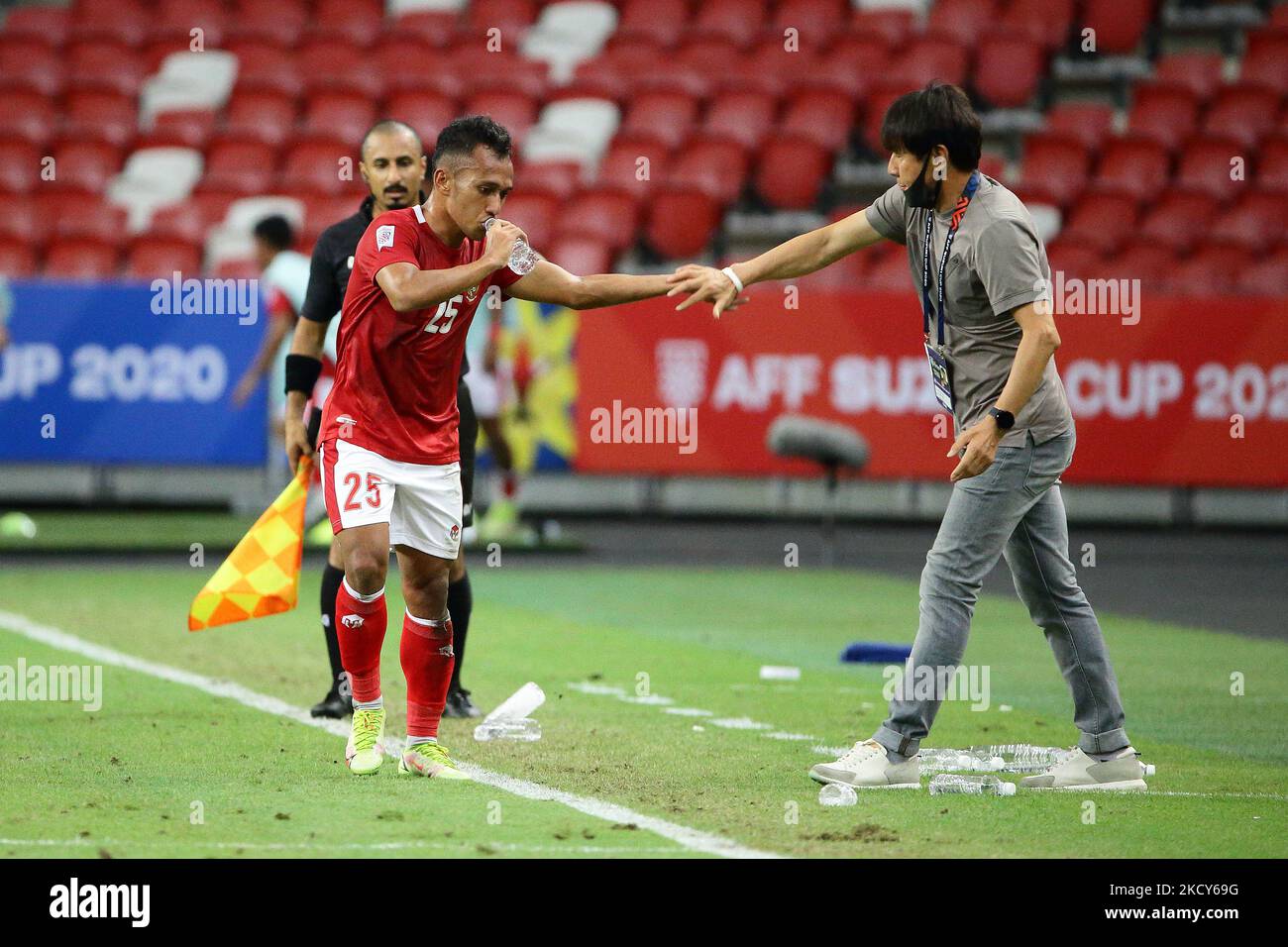 Indonesia head coach, Shin Tae Yong (R) congratulates Irfan Samaling Kumi after scoring the second goal during the AFF Suzuki Cup 2020 Group B match between Malaysia and Indonesia at National Stadium on December 19, 2021 in Singapore. (Photo by Suhaimi Abdullah/NurPhoto) Stock Photo