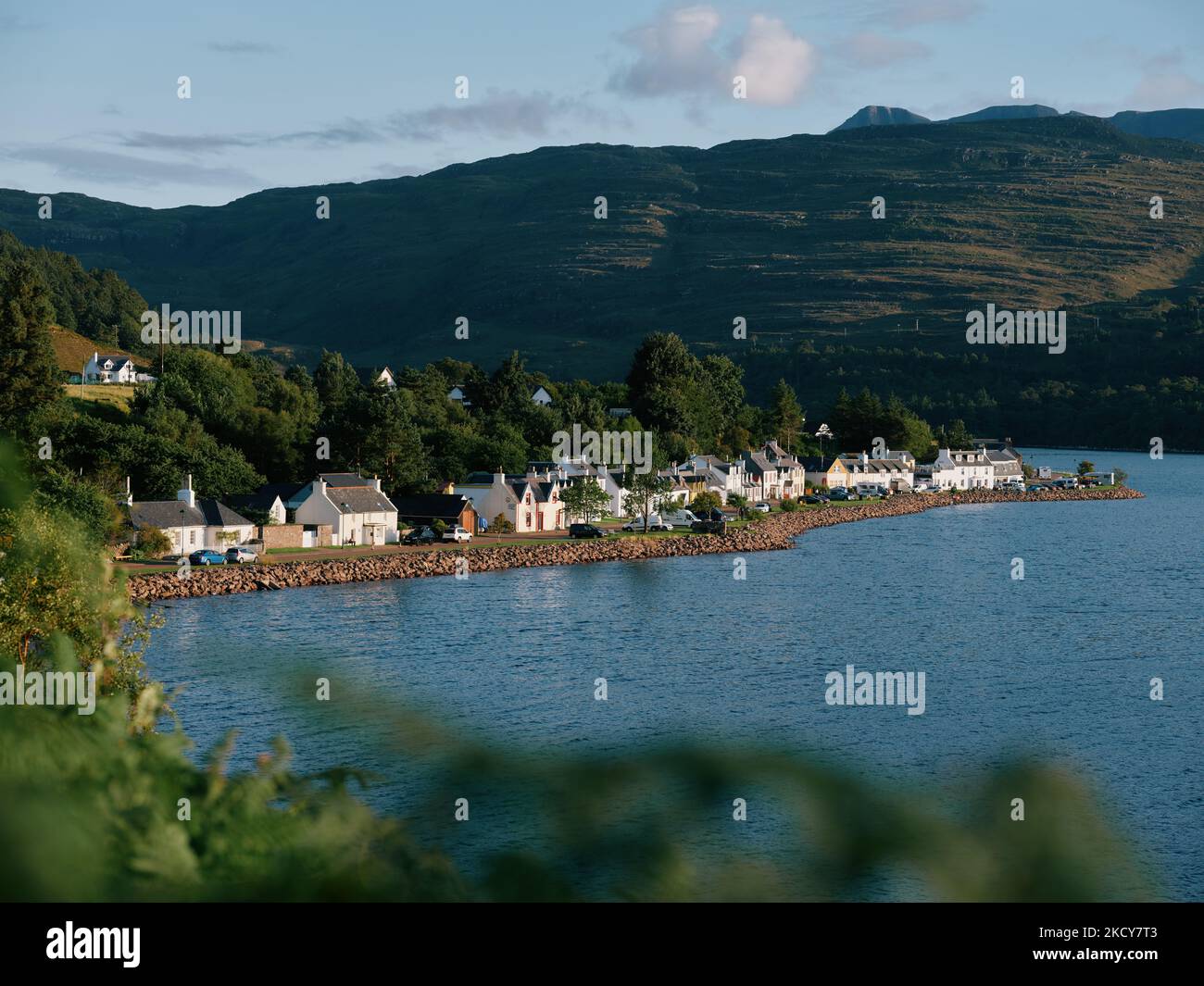 The summer loch and mountain landscape of Loch Shieldaig and village in Wester Ross, Highland, Scotland UK Stock Photo