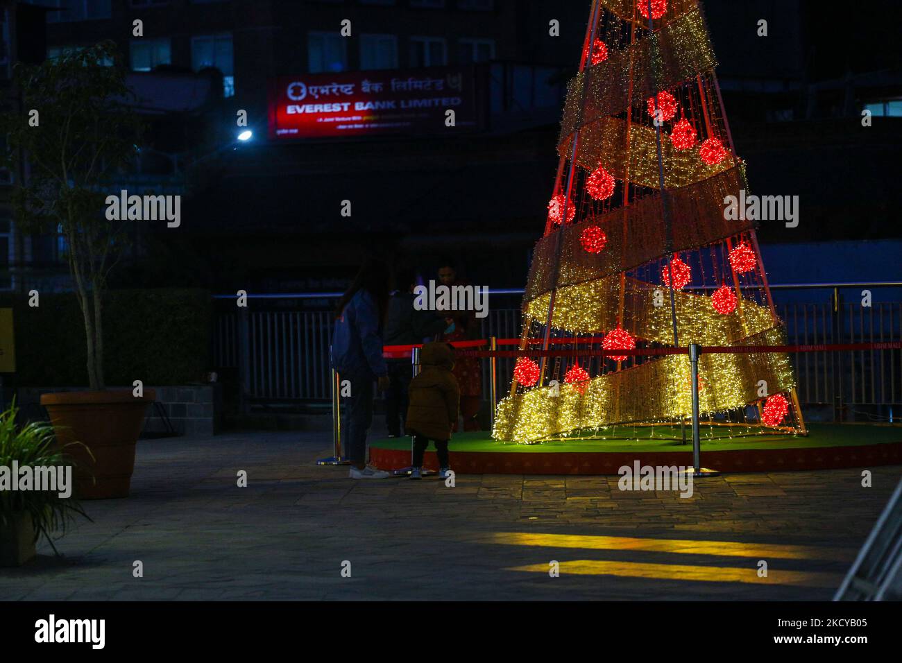 People enjoy Christmas lights and decorations at the shopping mall