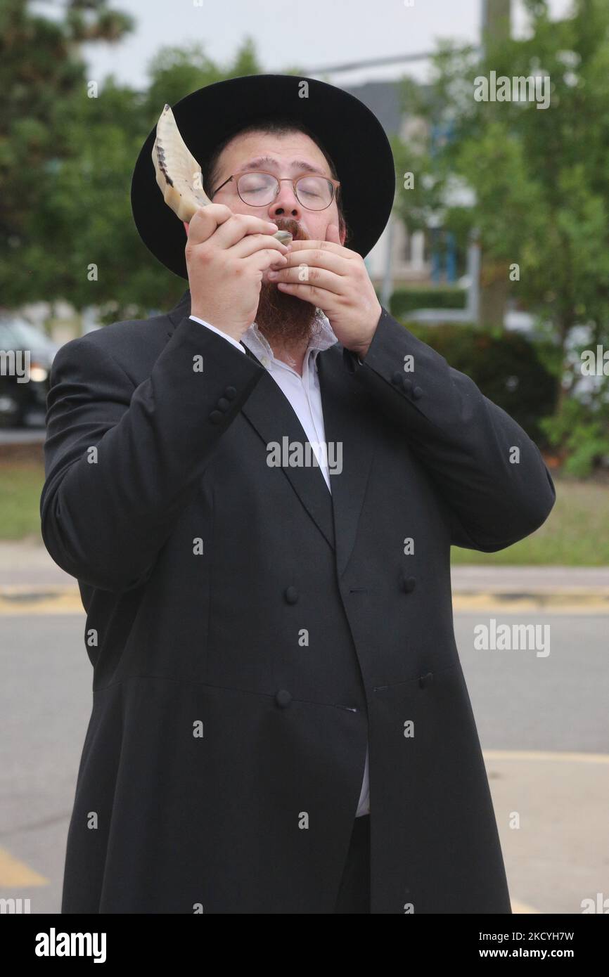 Rabbi blows the shofar (a rams horn) during the holiday of Rosh