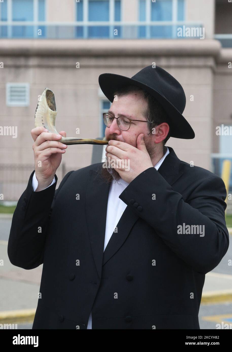 Rabbi blows the shofar (a rams horn) during the holiday of Rosh