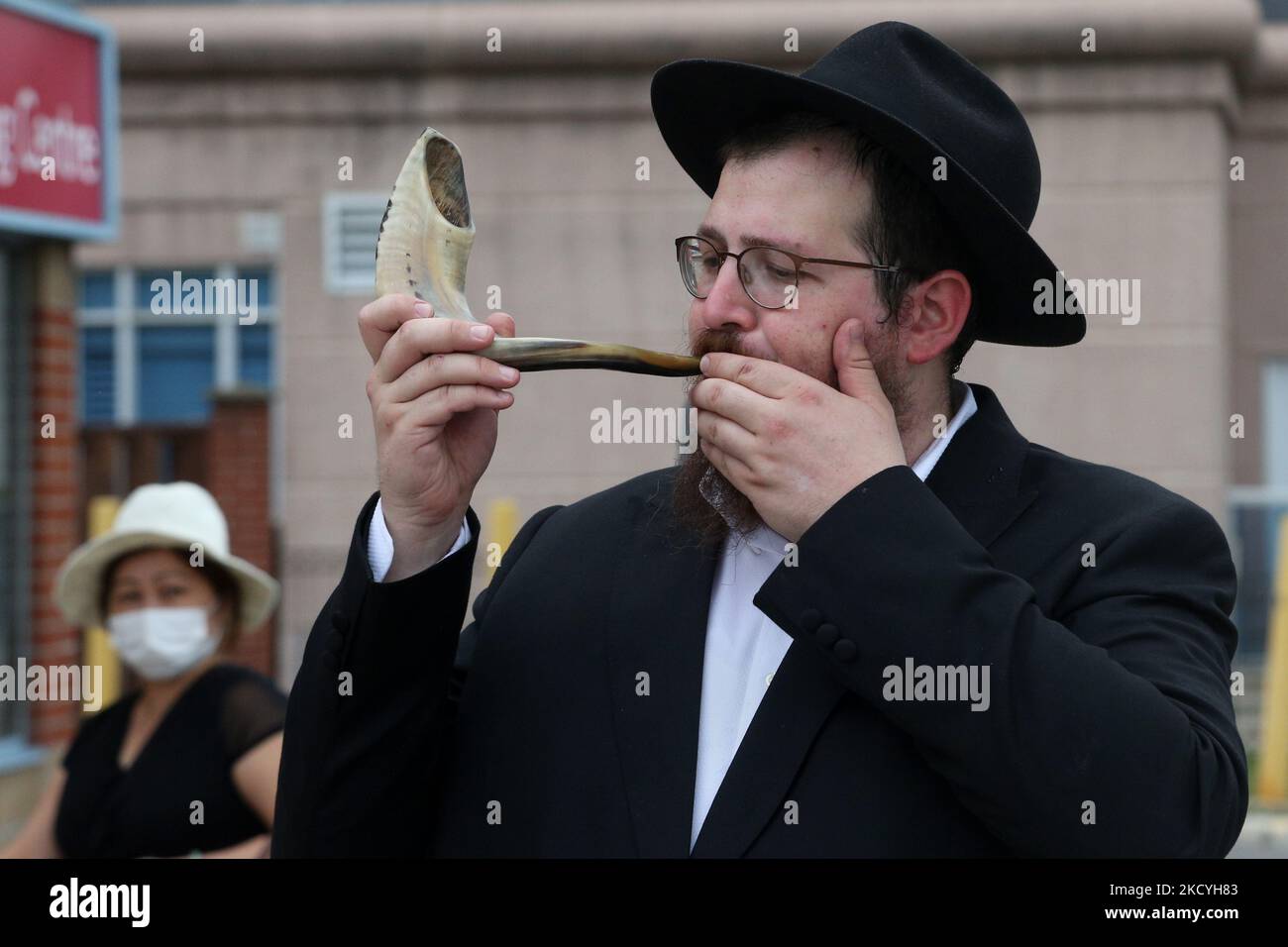 Rabbi blows the shofar (a rams horn) during the holiday of Rosh