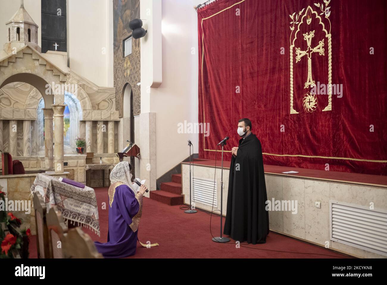 An Iranian-Christian clergyman and a clergywoman pray during a New Year  mass prayer ceremony in the Saint Sarkis church in downtown Tehran  following the new coronavirus disease (COVID-19) outbreak in Iran, January, image size:1300x956