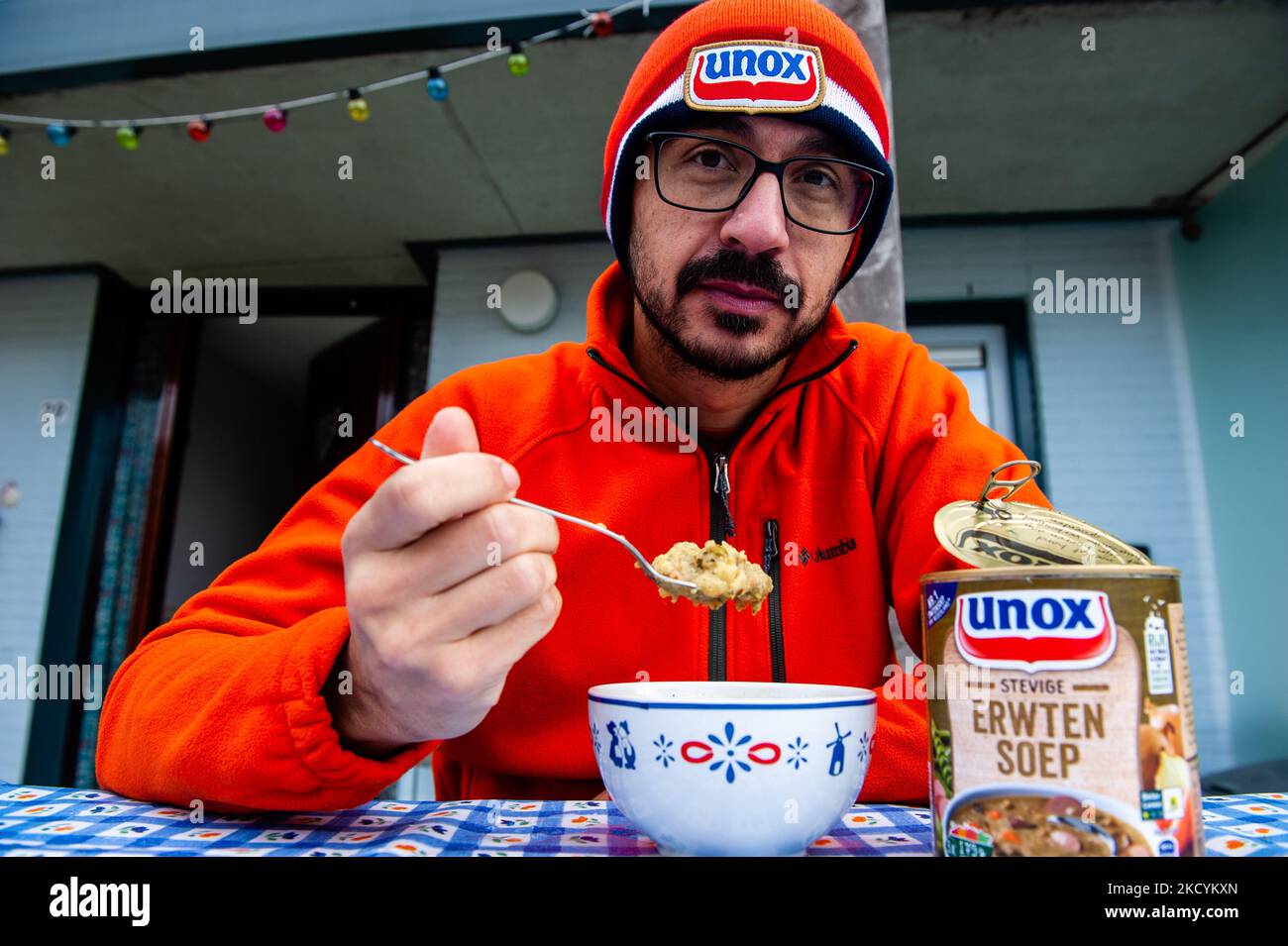 A man is eating a typical Dutch pea soup after celebrated the traditional New Year's dive again at home because of the pandemic. In Nijmegen, on January 1st, 2021. (Photo by Romy Arroyo Fernandez/NurPhoto) Stock Photo