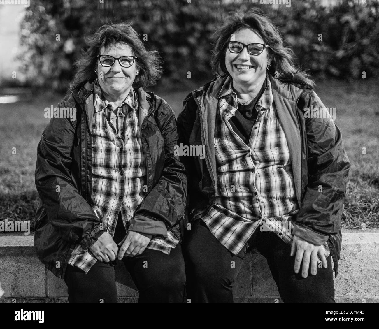 Black and white image of Spanish twins relaxing in London. Stock Photo