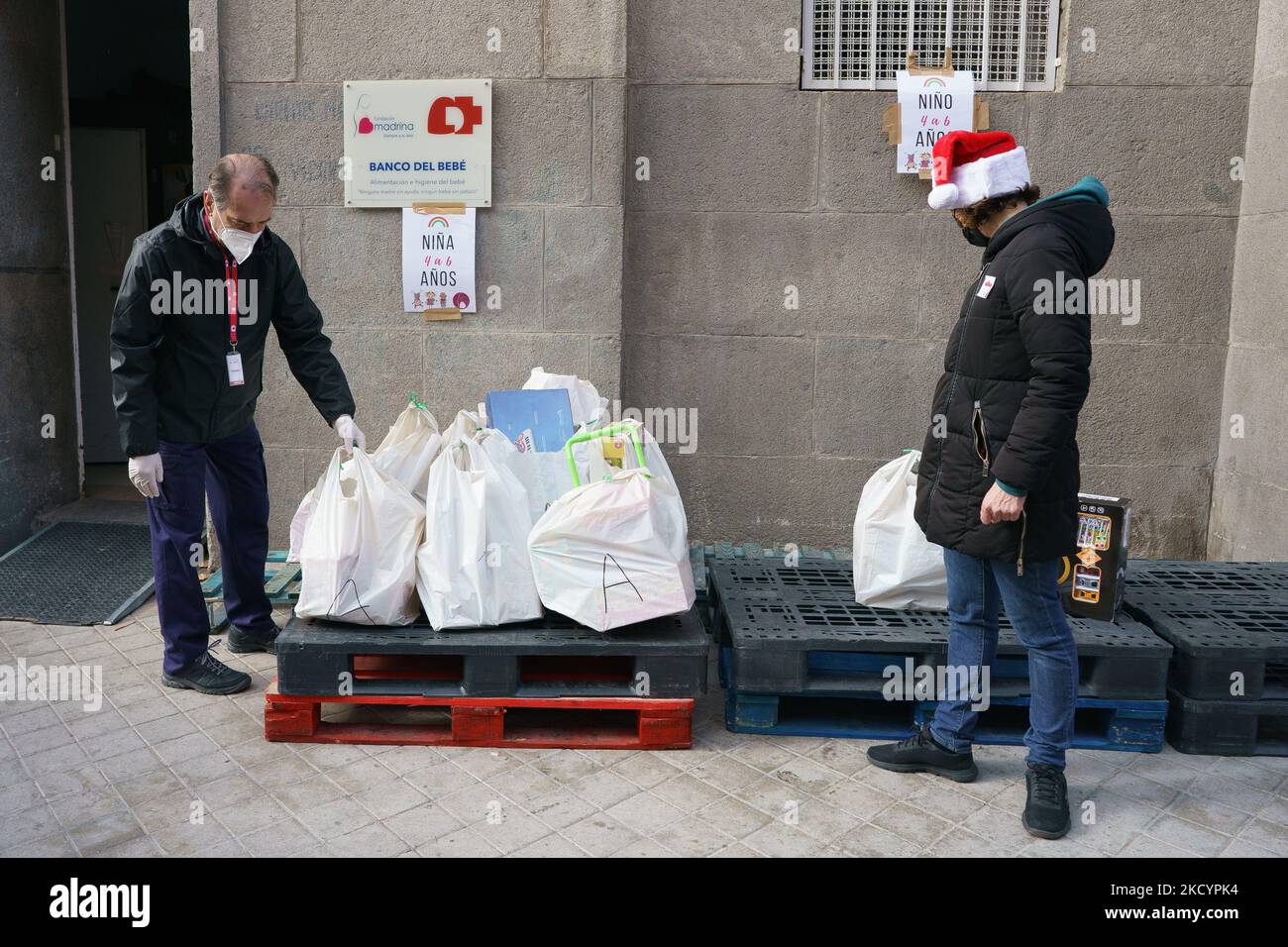A Volunteer Of The Fundacion Madrina Distributes Gifts To Children On a-volunteer-of-the-fundacion-madrina-distributes-gifts-to-children-on
