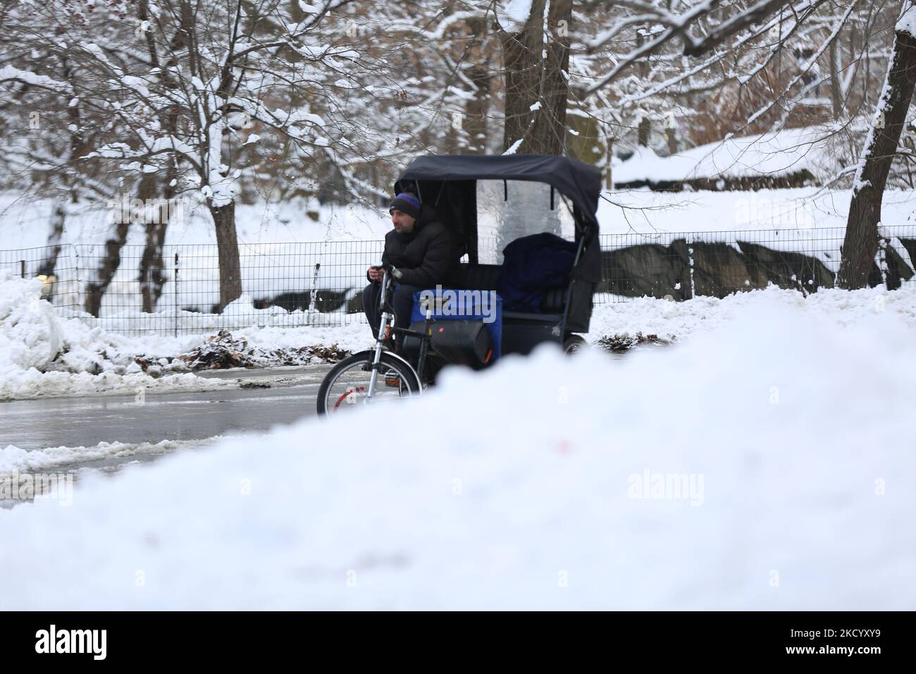 Bikerider waiting clients in Central Park, Manhattan, NYC on January