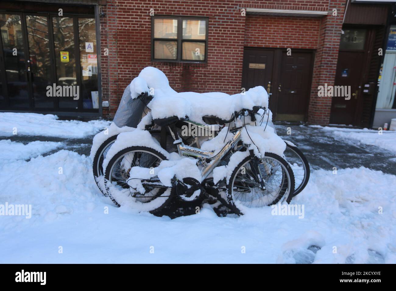 Couple of bikes covered with snow in Astoria, Queens, NYC on January