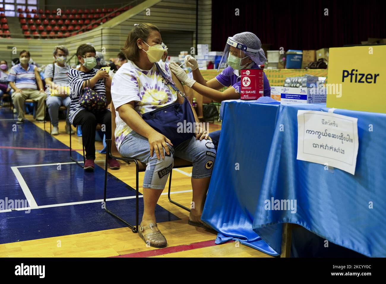 People receive doses of the Pfizer COVID-19 vaccine at a vaccination center inside a stadium in Bangkok, Thailand, 08 January 2022. (Photo by Anusak Laowilas/NurPhoto) Stock Photo