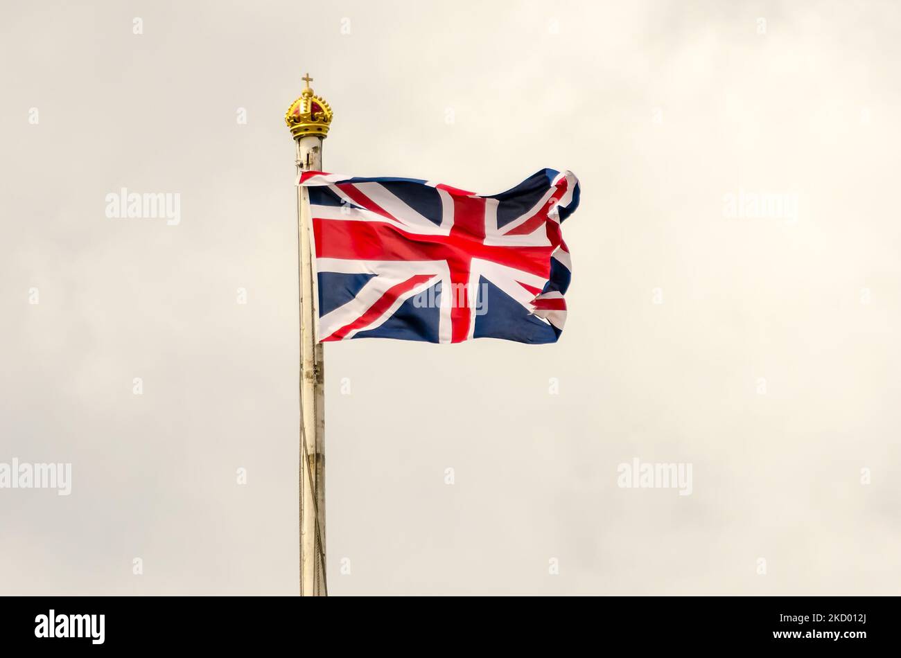 Union Jack Flag flying on a cloudy day in London, UK Stock Photo - Alamy