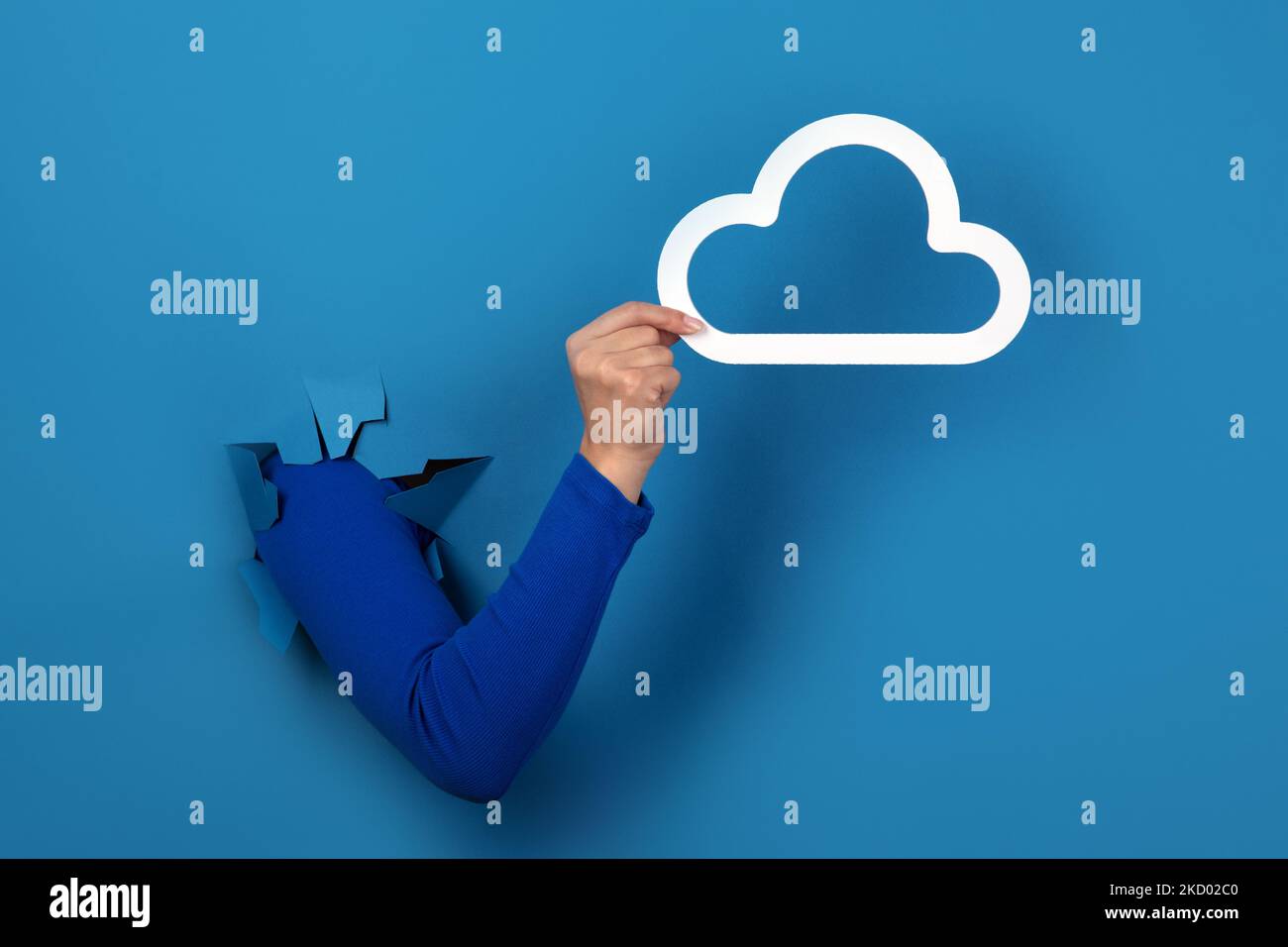 hand holding cloud storage over blue background Stock Photo