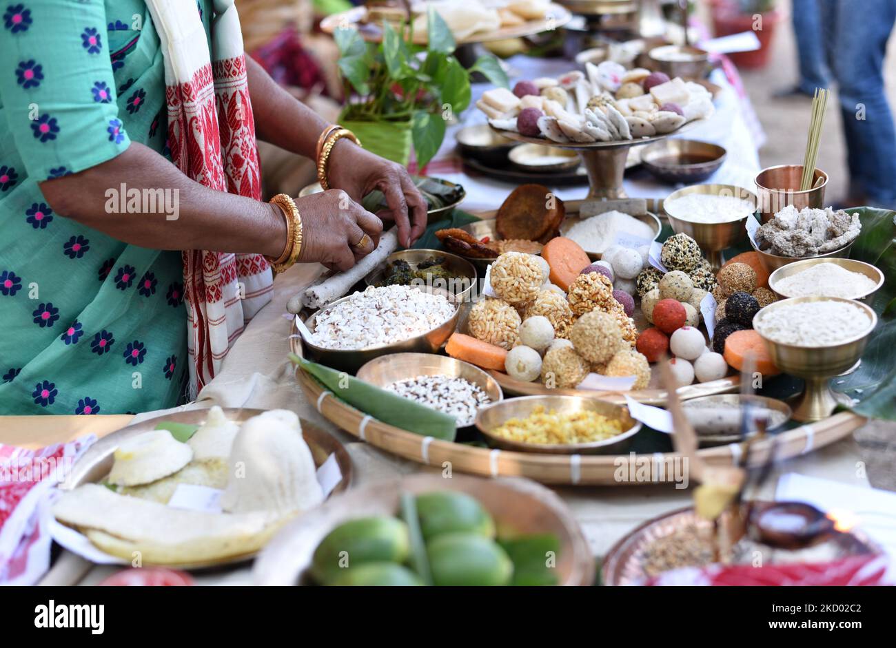 Assamese women displays Assamese traditional food items ahead of