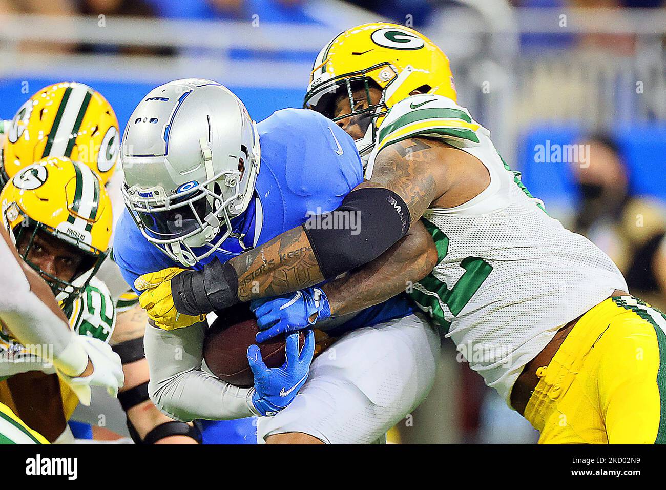 Detroit Lions running back D'Andre Swift (32) is tackled by Green Bay Packers outside linebacker Rashan Gary (52) during an NFL football game between the Detroit Lions and the Green Bay Packers in Detroit, Michigan USA, on Sunday, January 9, 2022. (Photo by Amy Lemus/NurPhoto) Stock Photo