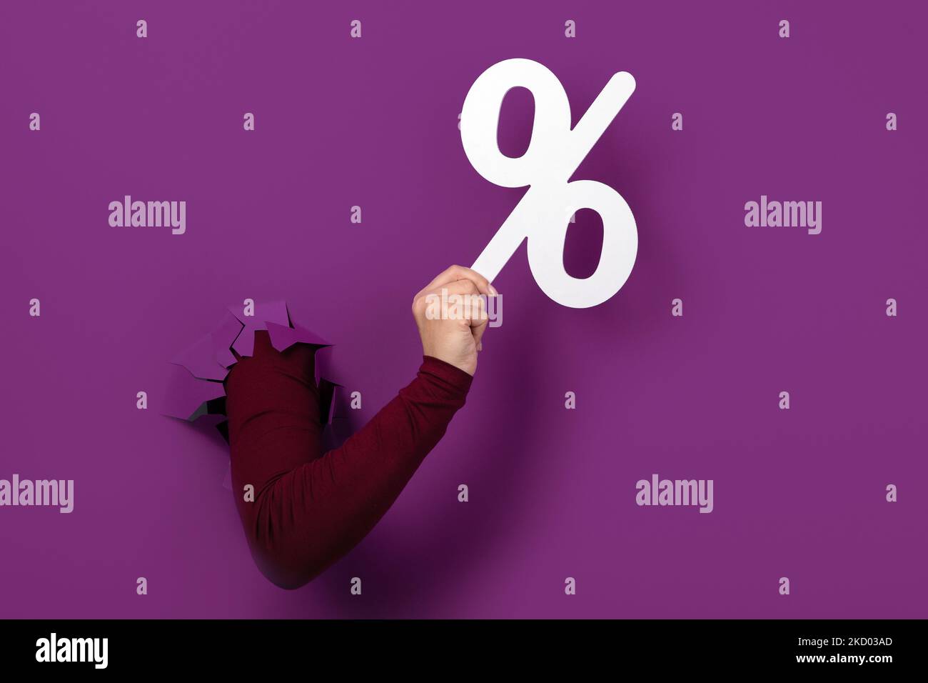 percentage symbol in hand over purple background Stock Photo - Alamy