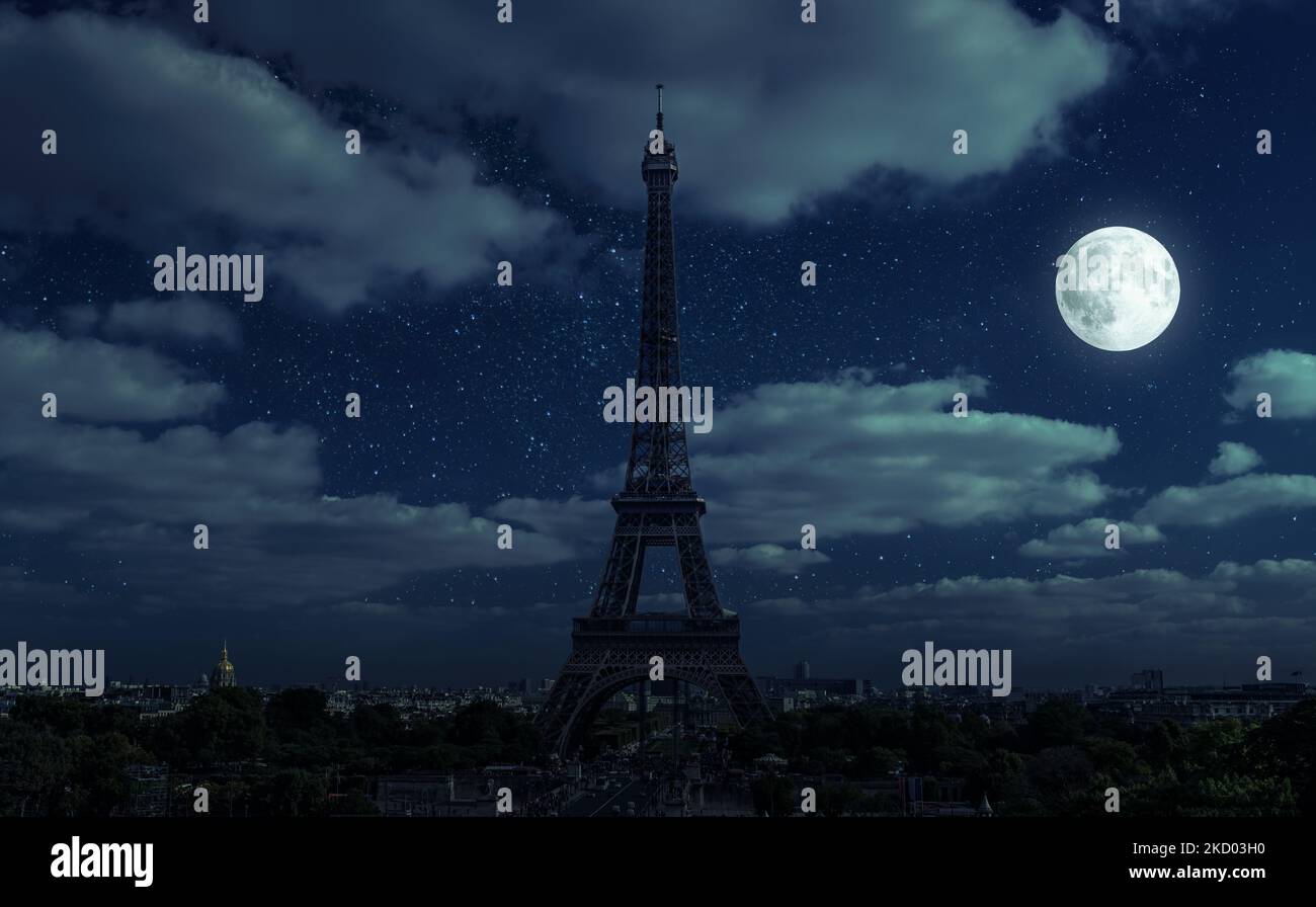 Paris at night during energy crisis, France. Full blackout of city due to expensive gas and electricity in Europe. View of Eiffel Tower and moon on da Stock Photo