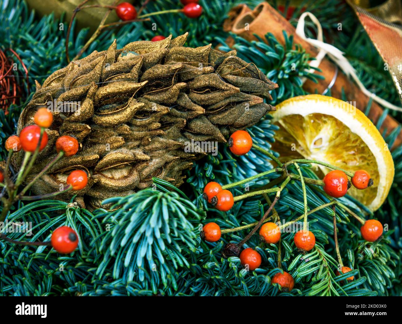 Christmas holiday decorations, festive composition with natural pine branches, cone, berries and baubles. Beautiful luxury ornament of Christmas tree Stock Photo