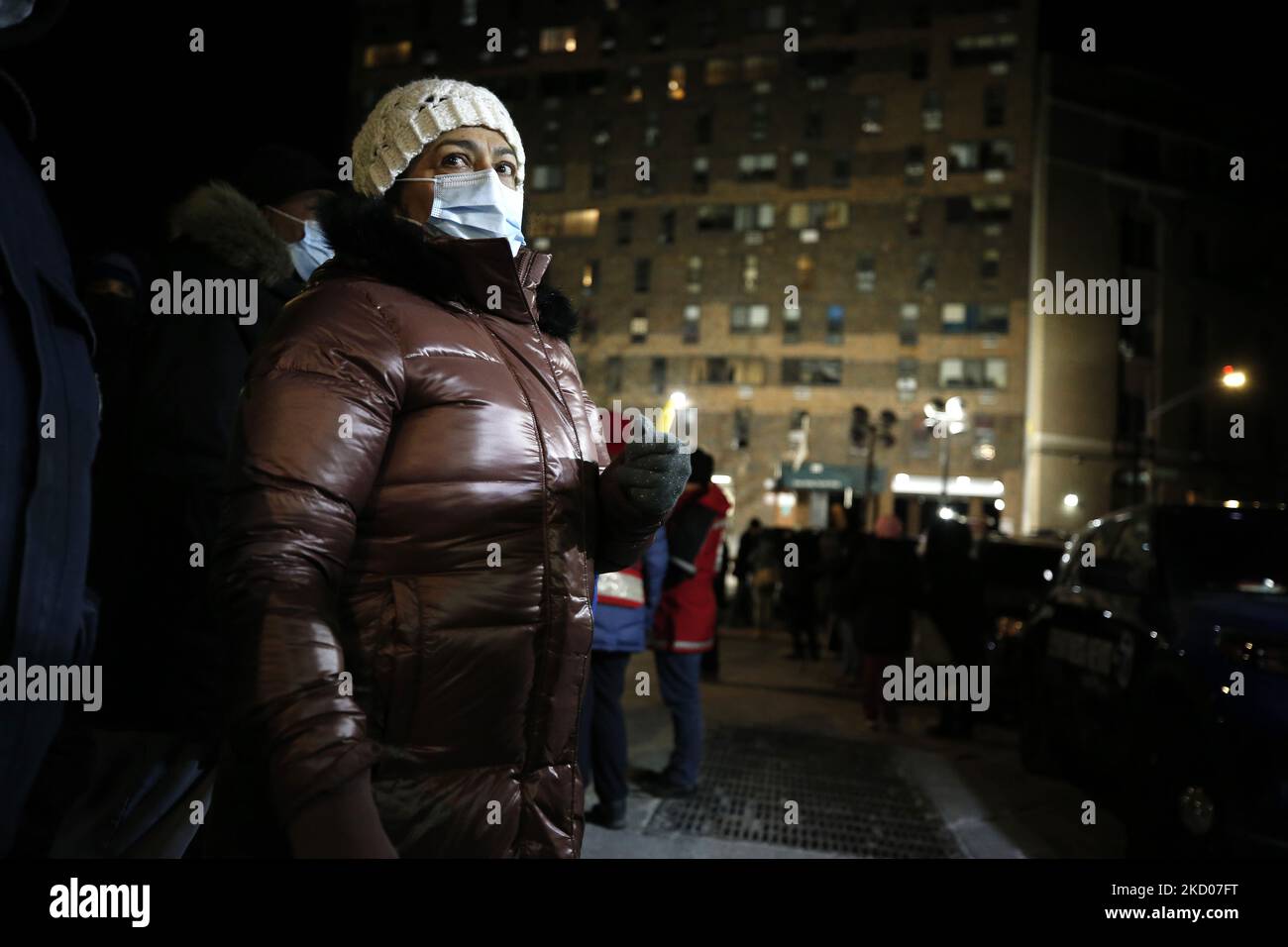 people-attend-a-vigil-in-front-of-a-hi-rise-building-where-seventeen