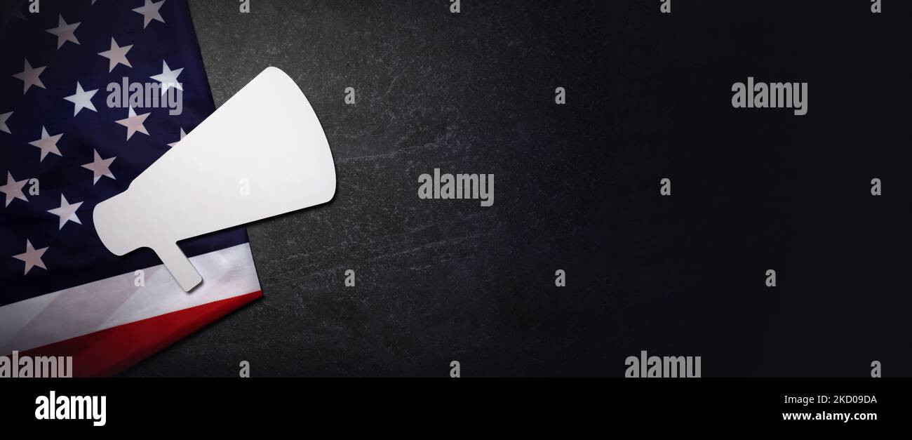 Advertising campaign in USA concept, megaphone on US flag over marble