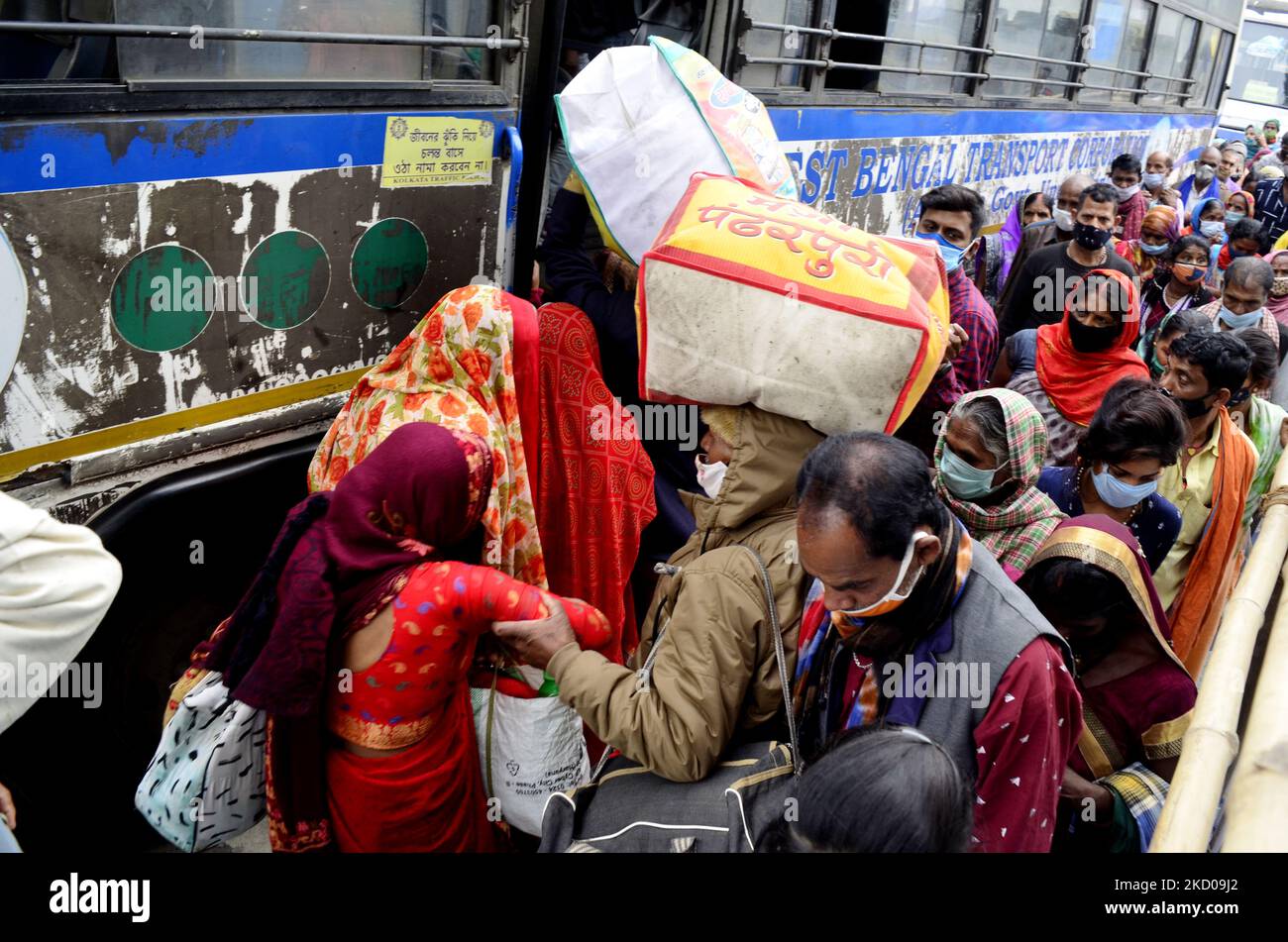 Devotees gather to board a bus for Gangasagar Mela amid coronavirus emergency in Kolkata, India, 13 January, 2022. (Photo by Indranil Aditya/NurPhoto) Stock Photo
