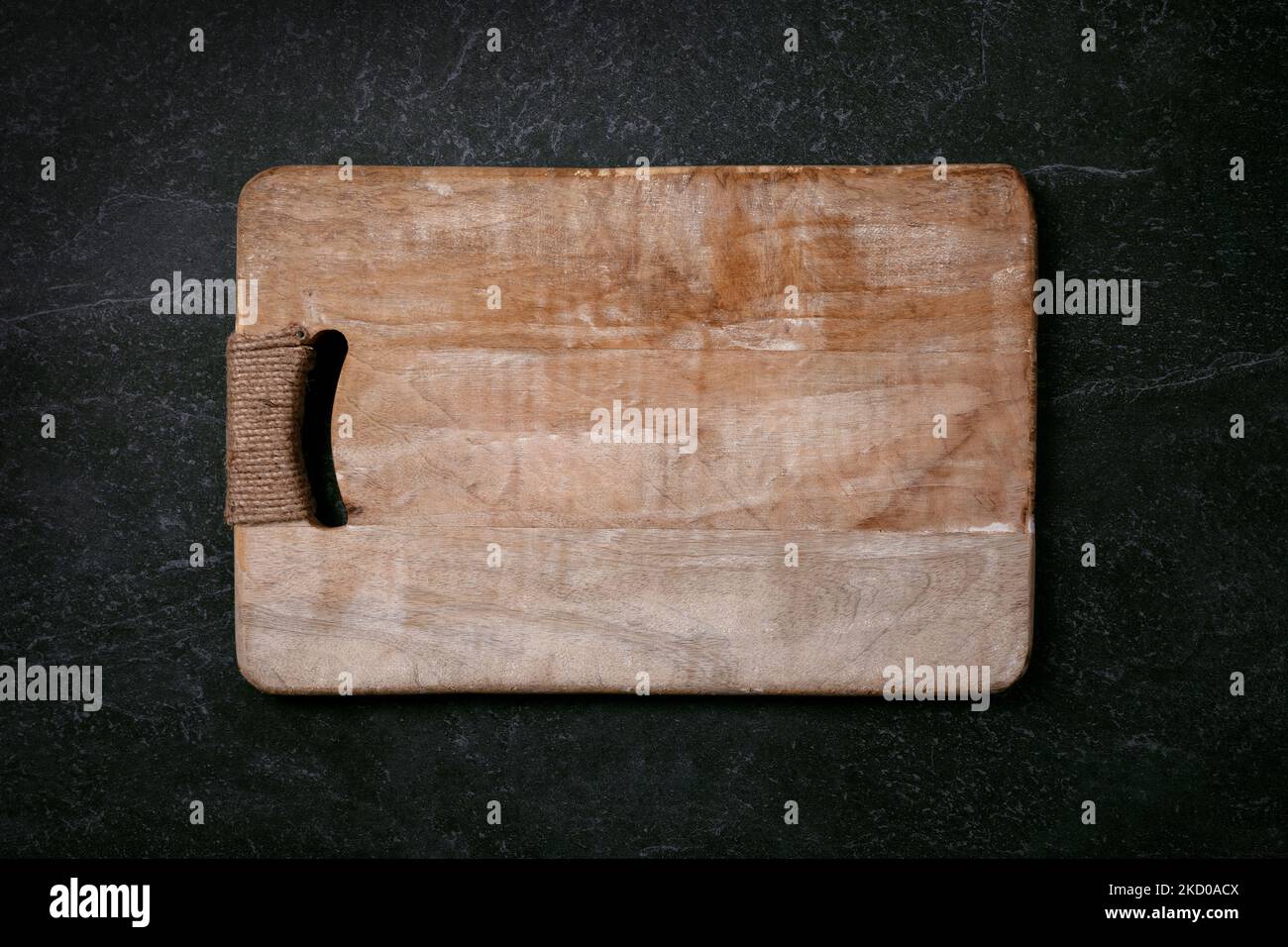 Empty cutting wood board on dark marble background, layout image Stock Photo