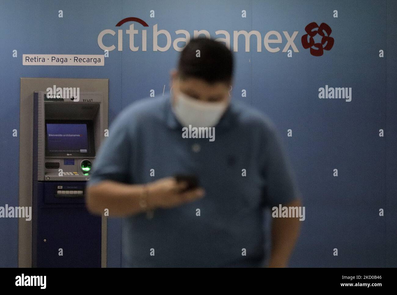 A person in front of a CitiBanamex bank ATM inside Terminal 1 of Mexico City International Airport during the health emergency and the green epidemiological traffic light in the capital. (Photo by Gerardo Vieyra/NurPhoto) Stock Photo