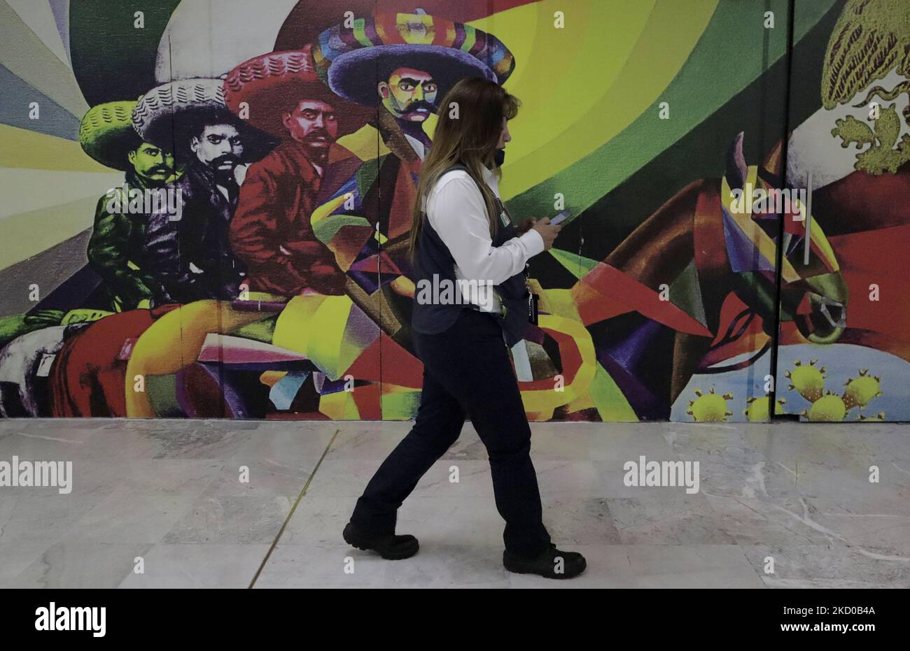 A person in front of a mural of Emiliano Zapata inside Terminal 1 of Mexico City International Airport during the health emergency and the green epidemiological traffic light in the capital. (Photo by Gerardo Vieyra/NurPhoto) Stock Photo