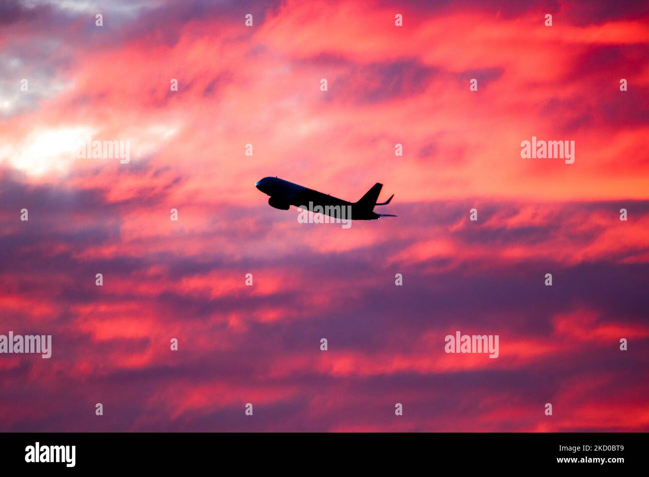 Aircraft silhouette symbol illustration photo during the magic hour. Dusk and sunset golden hour a colorful cloudy sky in Eindhoven. Images of Boeing and Airbus aircraft departing and flying in the