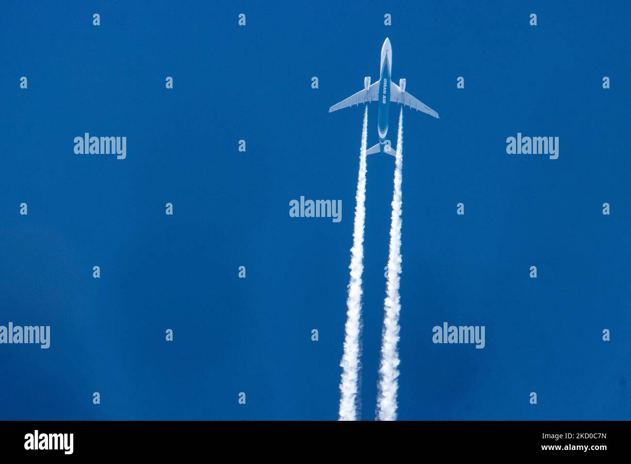 Oman Air Airbus A330 wide-body aircraft as seen flying at 40.000 feet of the Dutch city of Eindhoven during a clear blue sky day. The airline is the national carrier of the Sultanate of Oman a country on the southeastern coast of the Arabian Peninsula. The OMAN AIR logo inscription at the belly of the blue fuselage of the overfly plane is visible. The overflying airplane is traveling from the capital Muscat to London and leaves behind a white vapor condensation trail known as a contrail. The aviation industry and passenger traffic are phasing a difficult period with the Covid-19 coronavirus pa Stock Photo